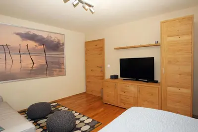 a bedroom with a flat screen tv on a wall at Apartma LODI BOHINJ Za dve,štiri, šest, ali osem oseb in Bohinj