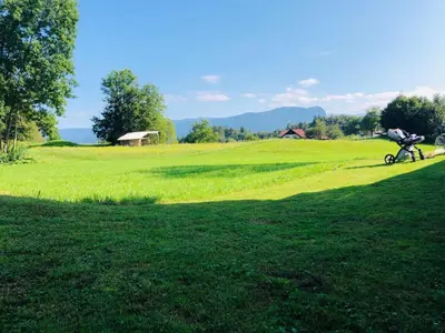 a person riding a bike in a grassy field at Apartma Eržen in Zgornje Gorje