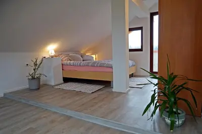 a bedroom with a bed in the corner of a room at Apartma Eržen in Zgornje Gorje