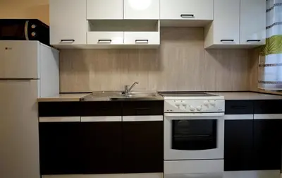 a kitchen with a white stove and a sink at Apartma Eržen in Zgornje Gorje