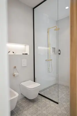 a bathroom with a toilet and a glass shower at Villa Majda in Osp