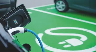 a car is parked on a street with a charging cord at Villa Majda in Osp