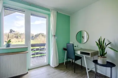 a room with a desk and a window at Deerwood Villa-Modern cozy 2br apartment with castle view in Bled