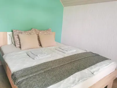 a bed with two towels on top of it at Deerwood Villa-Modern cozy 2br apartment with castle view in Bled