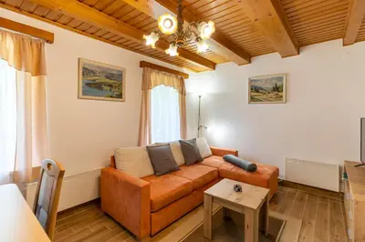 a living room with a couch and a table at Počitniška hiša Taler in Bohinj