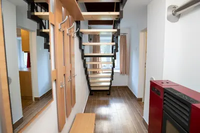 a room with a spiral staircase in a house at Počitniška hiša Taler in Bohinj