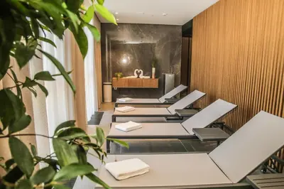 a spa room with a row of white chairs at Hotel A plus in Celje