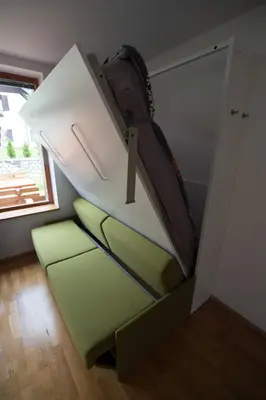 a room with a staircase with a couch and a table at APARTMENT ALPIN BOVEC in Bovec