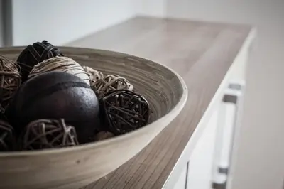 a wooden bowl filled with balls on a table at APARTMENT ALPIN BOVEC in Bovec
