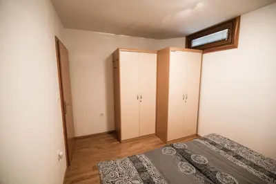 an empty bedroom with a bed and a window at APARTMENT ALPIN BOVEC in Bovec