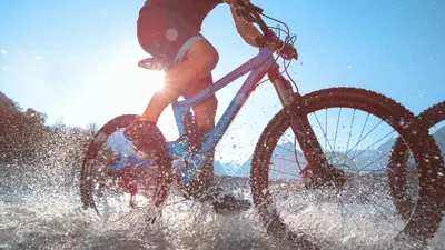 a person riding a bike in the water at APARTMENT ALPIN BOVEC in Bovec