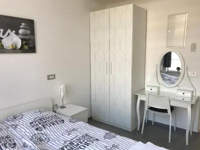 a bedroom with a bed and a desk and a mirror at Viktor in Ljubljana