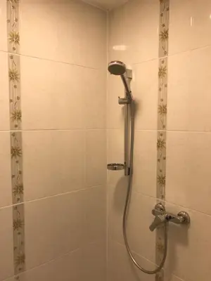a shower with a shower head in a bathroom at Viktor in Ljubljana
