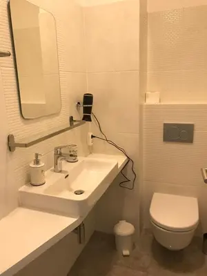 a bathroom with a sink and a toilet and a mirror at Viktor in Ljubljana