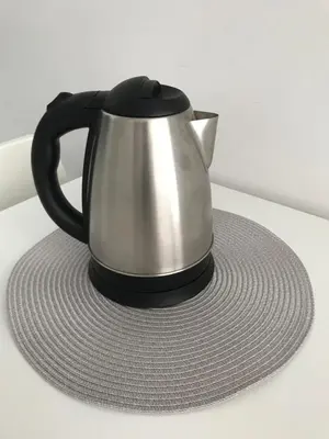 a black and silver tea kettle sitting on a table at Viktor in Ljubljana