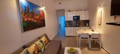 a living room with a couch and a table and a kitchen at Viktor in Ljubljana