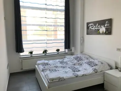 a small bedroom with a bed in front of a window at Viktor in Ljubljana