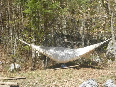 a hammock in the middle of a forest at Cottage Trenta in Bovec