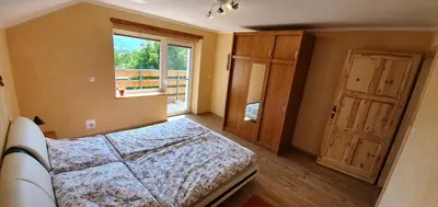 a bedroom with a bed and a window at Tree in Bled