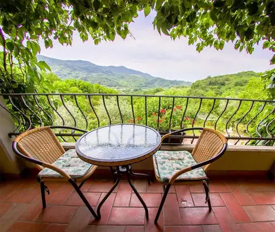 a table and two chairs on a balcony with a view at SOBE Andrejina in Branik