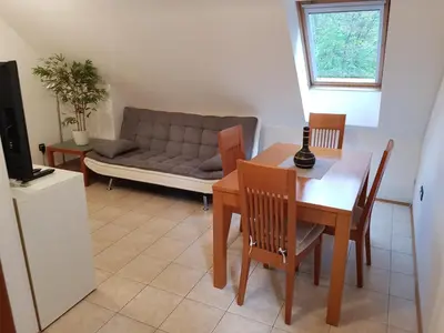 a living room with a table and a couch at Casa Monte in Bovec