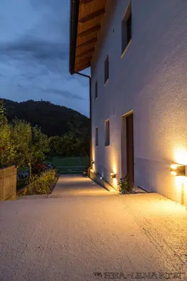 a building with lights on the side of it at Hiša Lenart in Tolmin