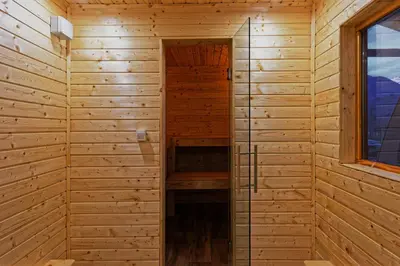 a sauna in a wooden cabin with a window at Hiša Lenart in Tolmin