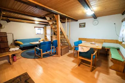 a room with a bunk bed and a table and chairs at Hiska Rutar Valley Voje in Studor v Bohinju
