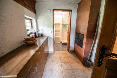 a kitchen with a wooden counter and a hallway at Hiska Rutar Valley Voje in Studor v Bohinju