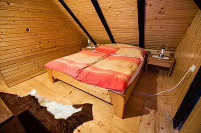 a bedroom with a bed in a wooden room at Hiska Rutar Valley Voje in Studor v Bohinju