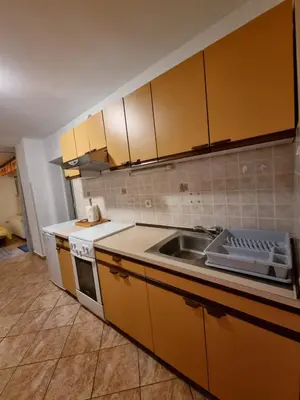 a kitchen with a sink and a stove and cabinets at Apartma Rutar in Tolmin