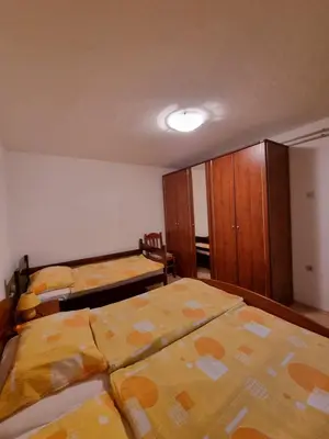 a bedroom with two beds and a closet at Apartma Rutar in Tolmin
