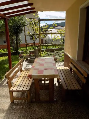 a picnic table and benches on a patio at Apartma Rutar in Tolmin