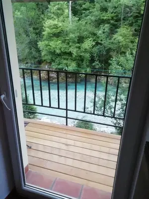 a view from the door of a porch with a wooden deck at Apartma Humar in Tolmin