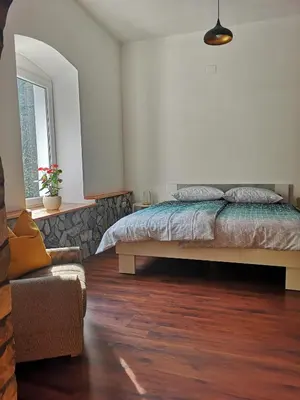 a bedroom with a bed and a couch in it at Apartma Humar in Tolmin