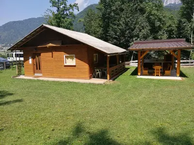 a small cabin with a gazebo in a field at Bungalow Perun in Blejska Dobrava