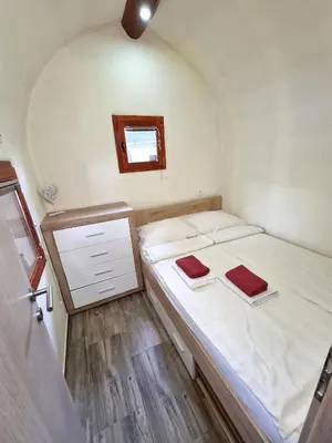 a small room with a bed and a window at Glamping Rajska vas in Šentjur
