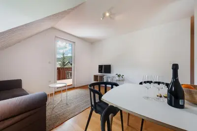 a living room with a white table and a couch at Villa Planina in Rateče