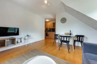 a living room with a couch and a table with chairs at Villa Planina in Rateče