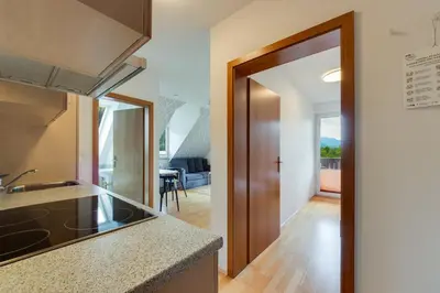 a kitchen with a door leading to a living room at Villa Planina in Rateče