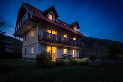a large house with its lights on at night at Villa Planina in Rateče
