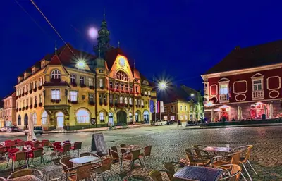 a city street with tables and chairs in front of buildings at Bed & Breakfast Šilak in Ptuj