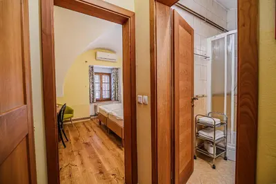 a hallway with a room with a bed and a mirror at Bed & Breakfast Šilak in Ptuj