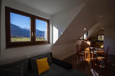 a living room with a couch and a table at Apartment Jezero Lake Bohinj in Bohinj