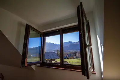 an open window with a view of a mountain at Apartment Jezero Lake Bohinj in Bohinj