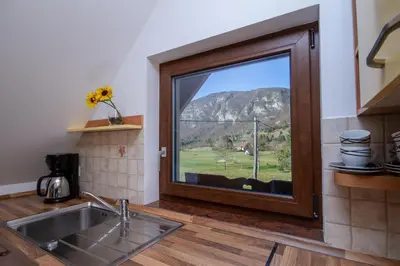 a kitchen with a window with a view of a mountain at Apartment Jezero Lake Bohinj in Bohinj