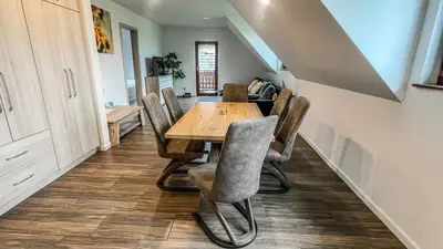 a dining room with a wooden table and chairs at Apartment Jezero Lake Bohinj in Bohinj