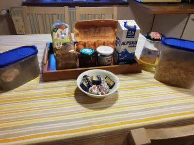 a table with a box of food and a bowl of food at Apartment Sopar in Škofja Loka
