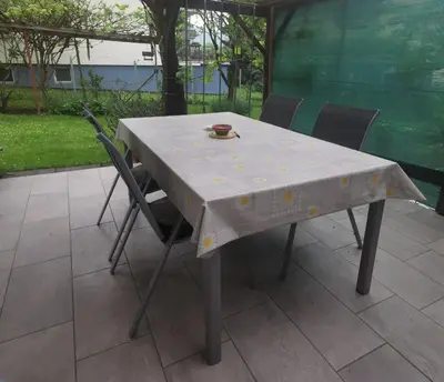 a table with a white table cloth on it at Apartment Sopar in Škofja Loka