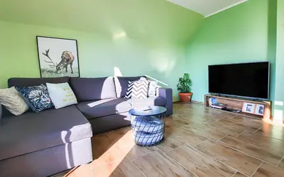 a living room with a couch and a flat screen tv at Deerwood-Large Villa relax with castle view in Bled